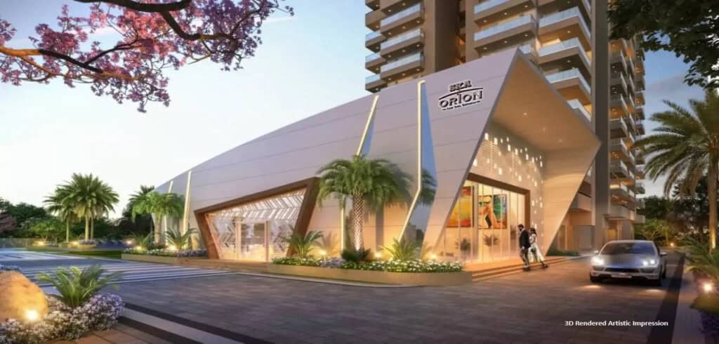 Luxurious residential building entrance with modern architecture and tropical landscaping.