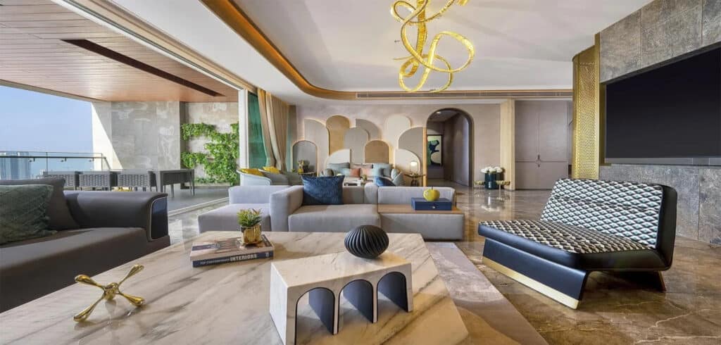 Luxurious modern living room with stylish furniture, open balcony, and city views for upscale real estate.